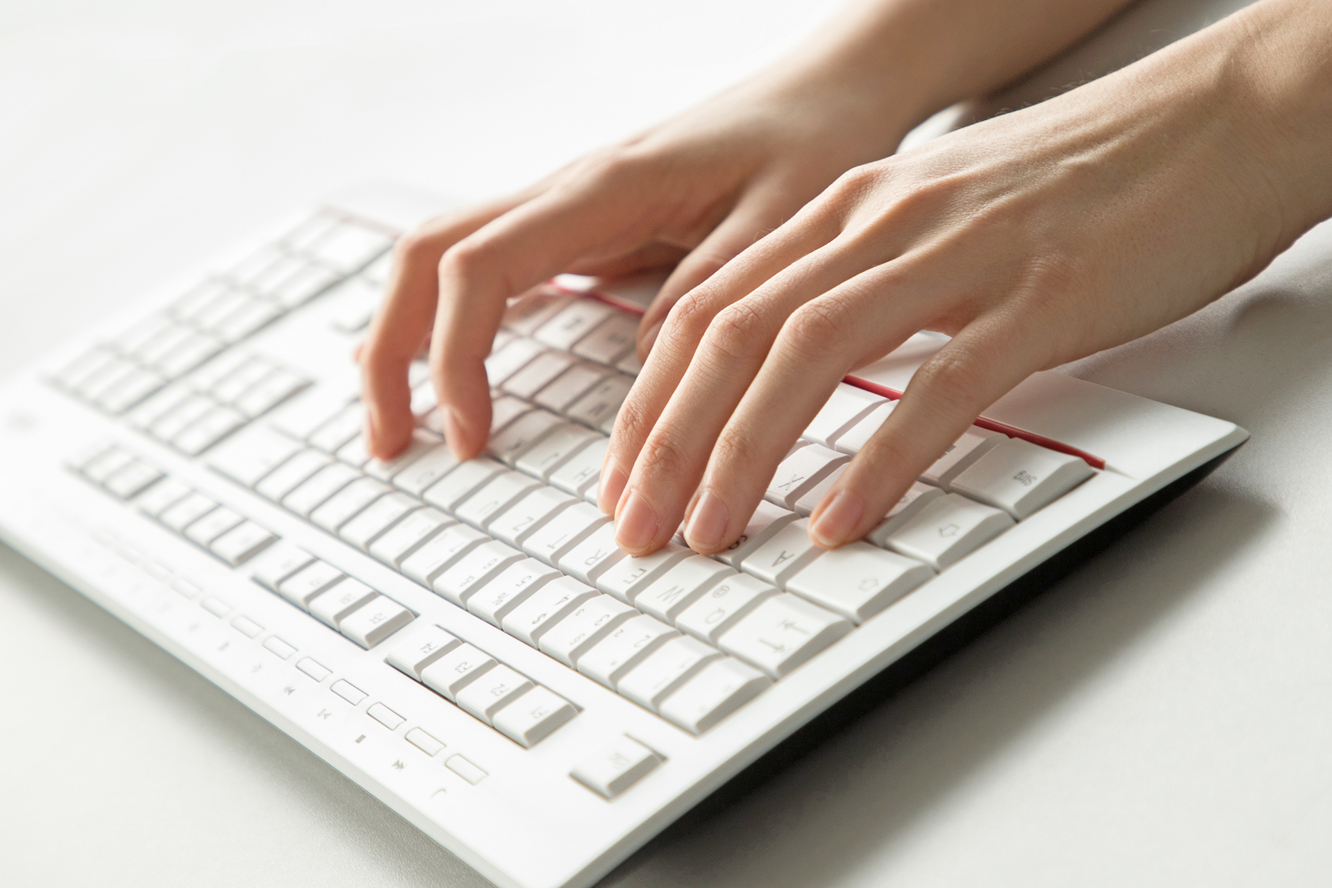 Hands above a keyboard