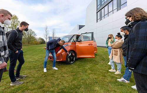 Kai Grünitz, Entwicklungsleiter Volkswagen Nutzfahrzeuge, (mitte) erläutert Studierenden am NFF den neuen ID.Buzz