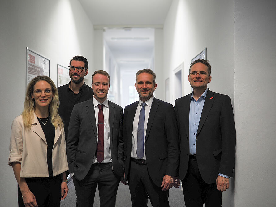 Porträtfoto von Doktorand und Prü­fungs­kom­mis­si­on