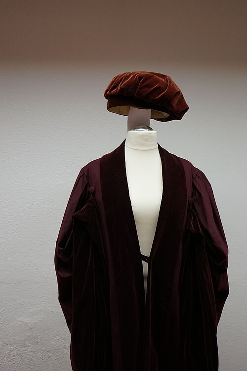Gown with headgear, as worn at official events. 