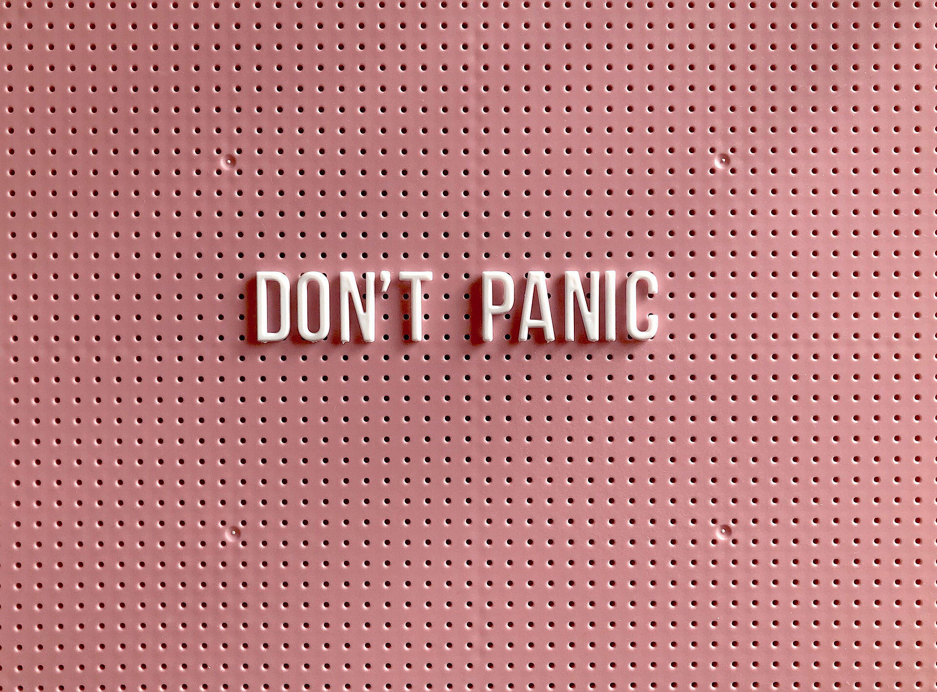 Lettering "Don't Panic" on pink background
