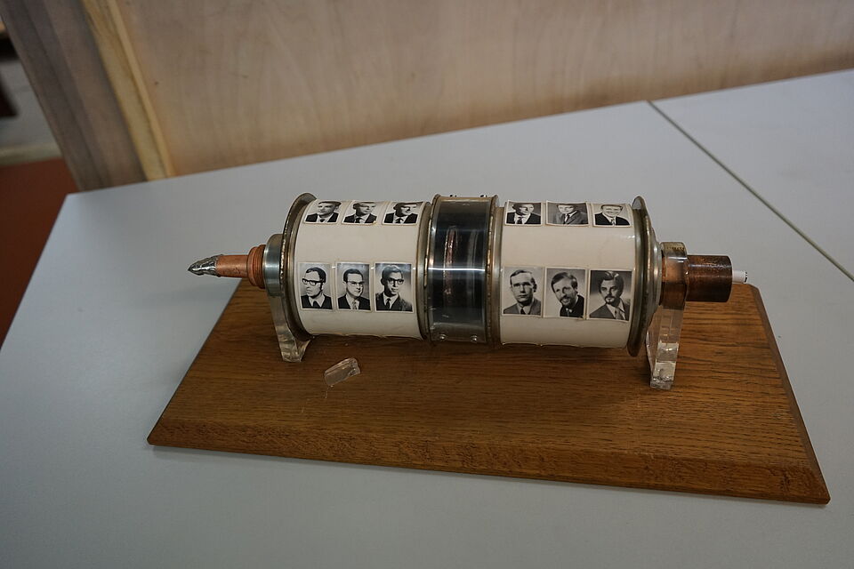 Coil for generating static charge. It was provided with the photos of the employees of the Institute of High Voltage Technology.                               