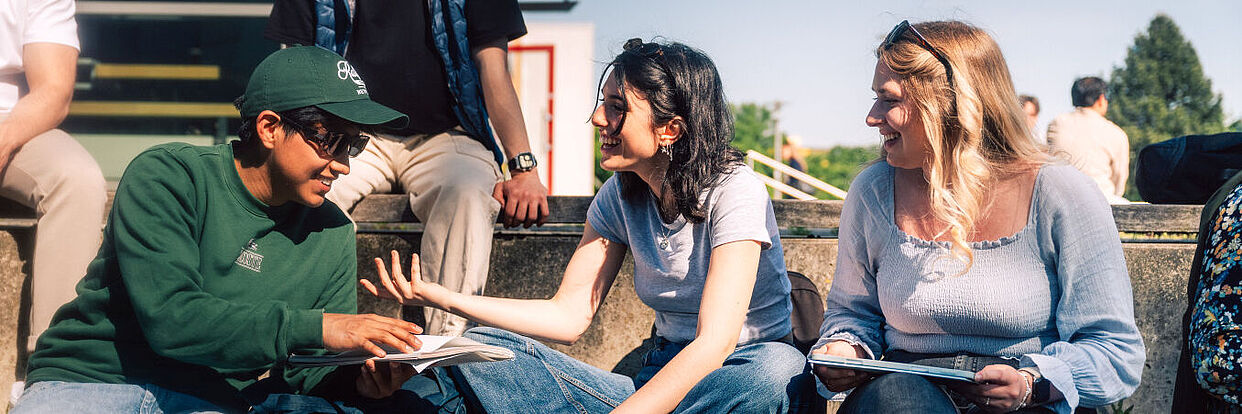 Students sitting on TU Braunschweig Campus Nord 