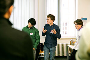 Conference participants engage in lively discussions during a workshop.