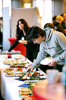 Conference participants help themselves at the buffet.
