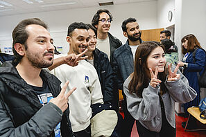 A group of students are taking a selfie. 