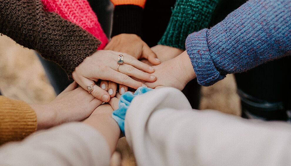 people putting their hands together