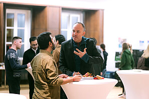 Two conference participants have a lively conversation.