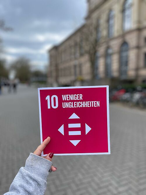 Eine Hand hält SDG 10