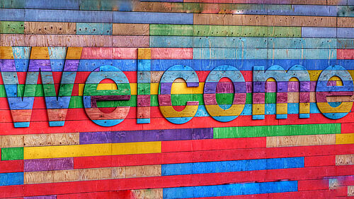Bunte Wand mit Schriftzug "Welcome"