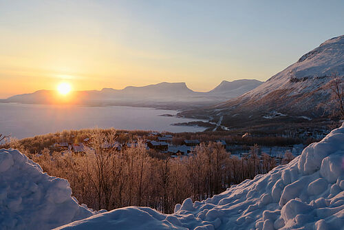 Sunrise over a lake in wintry Sweden.