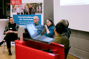 A participant in the panel discussion speaks into the microphone.