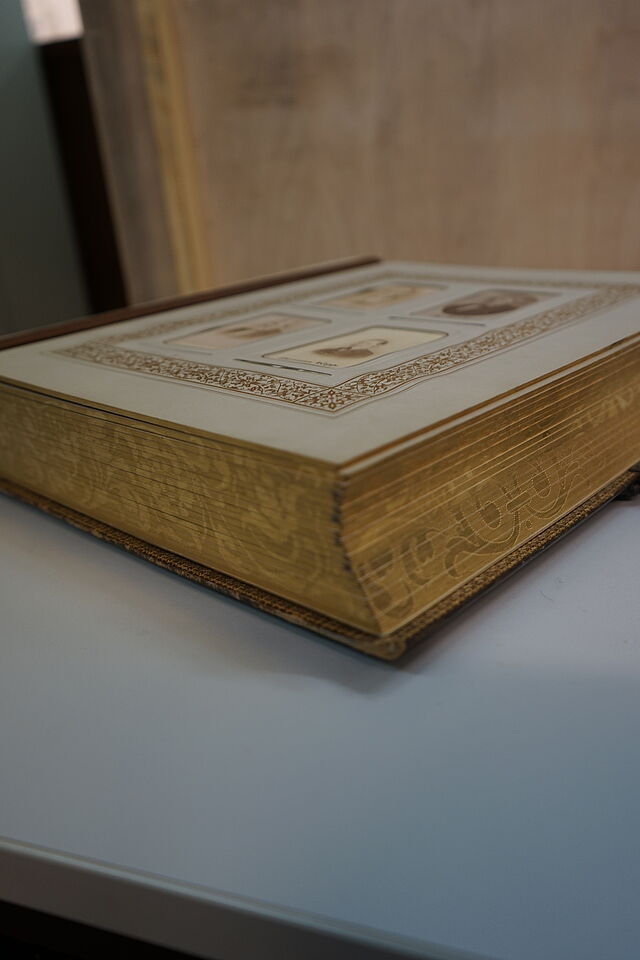 Side view of the decorative album with ornate gilt edges. The album contains 118 carte de visite from Prof Knapp's friends and admirers.