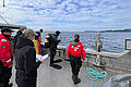 Researchers stand with a diver on a research boat.