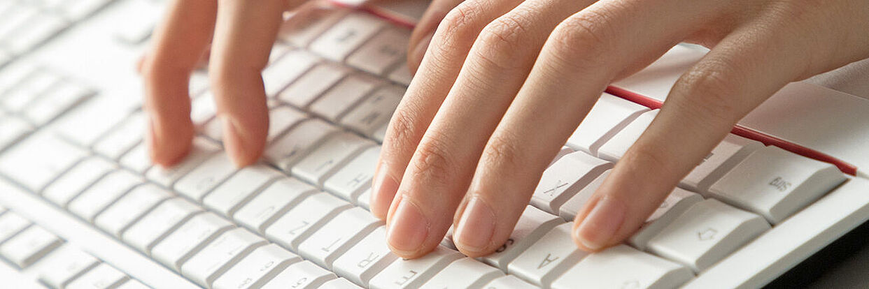 Hands above a keyboard 