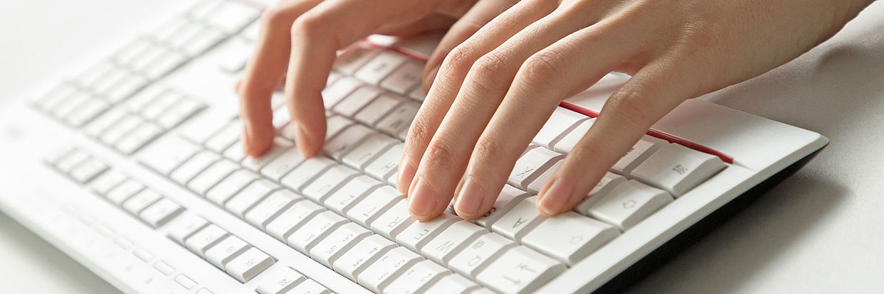 Hands above a keyboard 