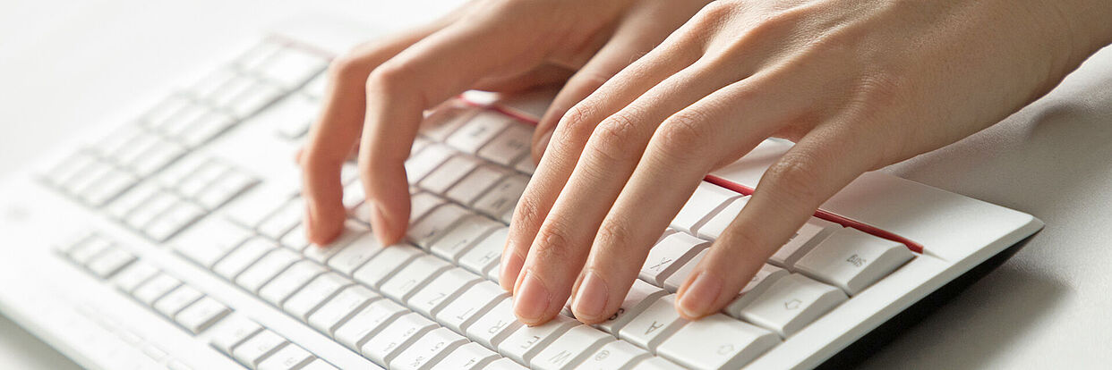 Hands above a keyboard 