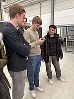 The students examine 3D prints from the IFL