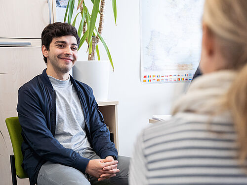 A student sits in a counselling situation.