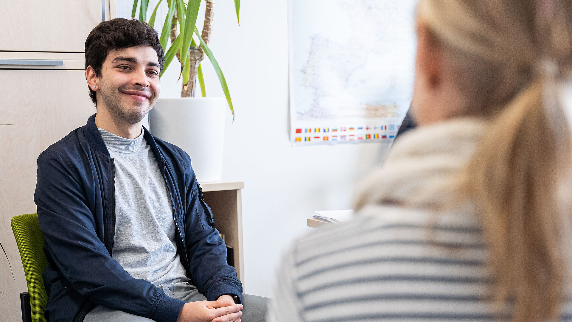 A student sits in a counselling situation.