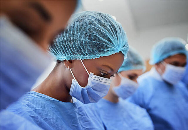 Cropped shot of a group of medical professionals performing surgery in the operating theatre