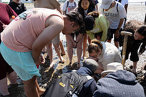 Summer School participants examine what they have found in the Wadden Sea off Cuxhaven.