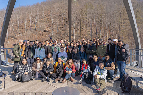 A group of students taking a group photo on the tree top walk in Bad Harzburg.