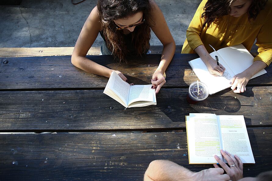 Three students learning outside